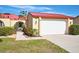 White garage door and red tile roof of charming villa at 1890 Deborah Dr # 14, Punta Gorda, FL 33950