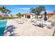 Community pool area with tables, chairs, and umbrellas at 1890 Deborah Dr # 14, Punta Gorda, FL 33950