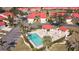 Community pool with surrounding patio furniture and landscaping at 1890 Deborah Dr # 14, Punta Gorda, FL 33950