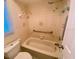 Bathroom with shower/tub combo, grab bars, and tile surround at 18938 Ayrshire Cir, Port Charlotte, FL 33948