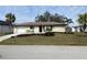 Newly renovated home with a landscaped lawn at 18938 Ayrshire Cir, Port Charlotte, FL 33948