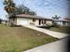 Newly renovated home with a landscaped lawn at 18938 Ayrshire Cir, Port Charlotte, FL 33948