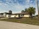 Single-story home with a well-maintained lawn and landscaping at 18938 Ayrshire Cir, Port Charlotte, FL 33948