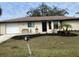 Newly renovated home with a landscaped lawn at 18938 Ayrshire Cir, Port Charlotte, FL 33948