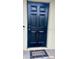 Dark-stained front door with a welcoming doormat at 18938 Ayrshire Cir, Port Charlotte, FL 33948