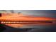 Stunning sunset over the water near a pier at 18938 Ayrshire Cir, Port Charlotte, FL 33948