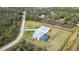 A high aerial shows a property with screened-in pool, a white home, detached garage, and winding stone driveway at 2154 Azure Rd, North Port, FL 34286