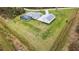 This expansive home with a detached garage, stone driveway, and screened pool sits on lush green grass at 2154 Azure Rd, North Port, FL 34286