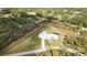 Aerial view showcasing a modern home with a pool, detached garage, and a spacious, verdant lawn at 2154 Azure Rd, North Port, FL 34286