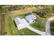 A high aerial shows a property with screened-in pool, a white home, detached garage, and winding stone driveway at 2154 Azure Rd, North Port, FL 34286