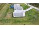 A high aerial shows a property with screened-in pool, a white home, detached garage, and winding stone driveway at 2154 Azure Rd, North Port, FL 34286