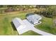 This expansive home with a detached garage, stone driveway, and screened pool sits on lush green grass at 2154 Azure Rd, North Port, FL 34286