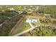 Aerial view showcasing a modern home with a pool, detached garage, and a spacious, verdant lawn at 2154 Azure Rd, North Port, FL 34286