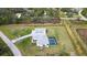 This stunning aerial shot features a house with a screened-in pool and a detached garage at 2154 Azure Rd, North Port, FL 34286
