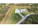 Aerial view showcasing a modern home with a pool, detached garage, and a spacious, verdant lawn at 2154 Azure Rd, North Port, FL 34286