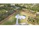 Aerial view showcasing a modern home with a pool, detached garage, and a spacious, verdant lawn at 2154 Azure Rd, North Port, FL 34286