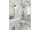 Elegant bathroom featuring a glass-enclosed shower, marble tile, and modern fixtures at 2154 Azure Rd, North Port, FL 34286