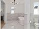 Bright bathroom with marble tile, modern fixtures, and a stand-alone soaking tub at 2154 Azure Rd, North Port, FL 34286