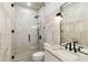 Modern bathroom featuring a glass shower, marble tile, updated vanity, and sleek black fixtures at 2154 Azure Rd, North Port, FL 34286