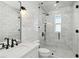 Bright bathroom boasts white marble tile, glass shower and sink at 2154 Azure Rd, North Port, FL 34286