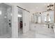 Bright bathroom offers marble floors, a glass-enclosed shower, double vanity, and closet at 2154 Azure Rd, North Port, FL 34286