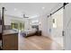 Light bedroom features wood floors, barn door, and views to the backyard at 2154 Azure Rd, North Port, FL 34286