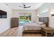 Bedroom offers a calm retreat with hardwood floors, a ceiling fan, and access to the pool area at 2154 Azure Rd, North Port, FL 34286