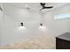 Bright bedroom with modern light fixtures, white paneled walls, and luxury flooring at 2154 Azure Rd, North Port, FL 34286