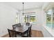 Bright dining room with seating for six, wood floors, and views of the pool in the back yard at 2154 Azure Rd, North Port, FL 34286