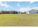 Wide backyard with a screened in pool, home, and detached garage at 2154 Azure Rd, North Port, FL 34286