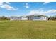 Charming exterior view of a modern, white home with a well-manicured lawn and detached garage at 2154 Azure Rd, North Port, FL 34286