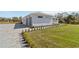 Exterior of house and attached garage with manicured lawn and landscape at 2154 Azure Rd, North Port, FL 34286