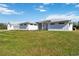 Charming exterior view of a modern, white home with a well-manicured lawn and detached garage at 2154 Azure Rd, North Port, FL 34286