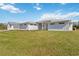 Charming exterior view of a modern, white home with a well-manicured lawn and detached garage at 2154 Azure Rd, North Port, FL 34286