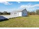 Three-car garage with white siding and a paved driveway on a sunny day at 2154 Azure Rd, North Port, FL 34286