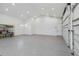 Spacious three car garage with epoxy flooring, storage shelving, and ample lighting at 2154 Azure Rd, North Port, FL 34286