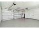Spacious garage with epoxy flooring, automatic door openers, and ample storage area at 2154 Azure Rd, North Port, FL 34286