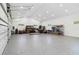 Spacious three car garage with epoxy flooring, storage shelving, and ample lighting at 2154 Azure Rd, North Port, FL 34286