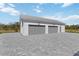 Exterior view of a two-car attached garage with brick driveway at 2154 Azure Rd, North Port, FL 34286