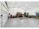 Spacious three car garage with epoxy flooring, storage shelving, and ample lighting at 2154 Azure Rd, North Port, FL 34286