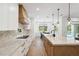 Modern kitchen with stainless steel appliances, stone counters and an island that overlooks the pool in the back yard at 2154 Azure Rd, North Port, FL 34286
