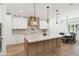 Bright kitchen with stone counters, a large island, and custom cabinets offers luxury and functionality at 2154 Azure Rd, North Port, FL 34286