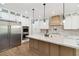 Modern kitchen with stainless steel appliances, custom cabinets and beautiful countertops for cooking and entertaining at 2154 Azure Rd, North Port, FL 34286