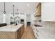 Modern kitchen with stainless steel appliances, stone counters and an island with beautiful wood detail at 2154 Azure Rd, North Port, FL 34286