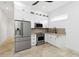 Modern kitchenette features stainless steel appliances, white cabinets, and sleek countertops at 2154 Azure Rd, North Port, FL 34286