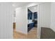 Hallway view of a stylish laundry room with blue cabinets, modern appliances, and marble countertops at 2154 Azure Rd, North Port, FL 34286