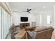 Bright living room boasts a ceiling fan, wood floors, and a view to the front entry at 2154 Azure Rd, North Port, FL 34286