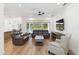 Open-concept living room featuring wood floors, comfortable seating, and sliding glass doors at 2154 Azure Rd, North Port, FL 34286