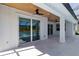 Covered patio with ceiling fan, and overlooks the sparkling screened-in pool and backyard at 2154 Azure Rd, North Port, FL 34286
