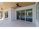 Covered patio features tongue and groove ceiling, ceiling fan, and large sliding glass doors to backyard at 2154 Azure Rd, North Port, FL 34286